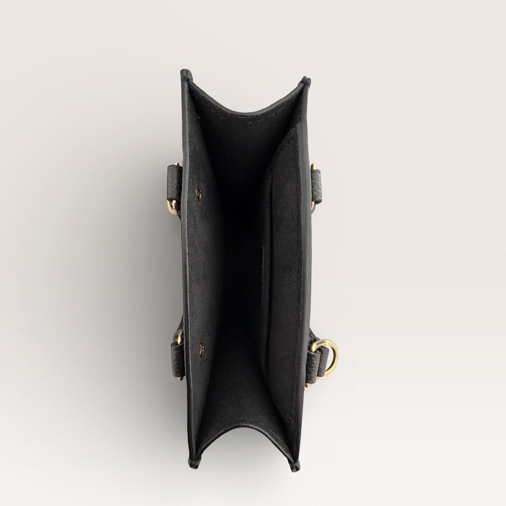 Louis Vuitton petit sac plat black empreinte mini tote top view of interior